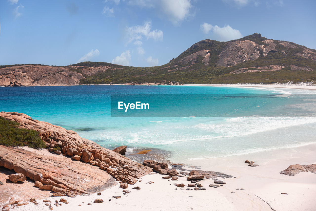 scenic view of sea and mountains against sky