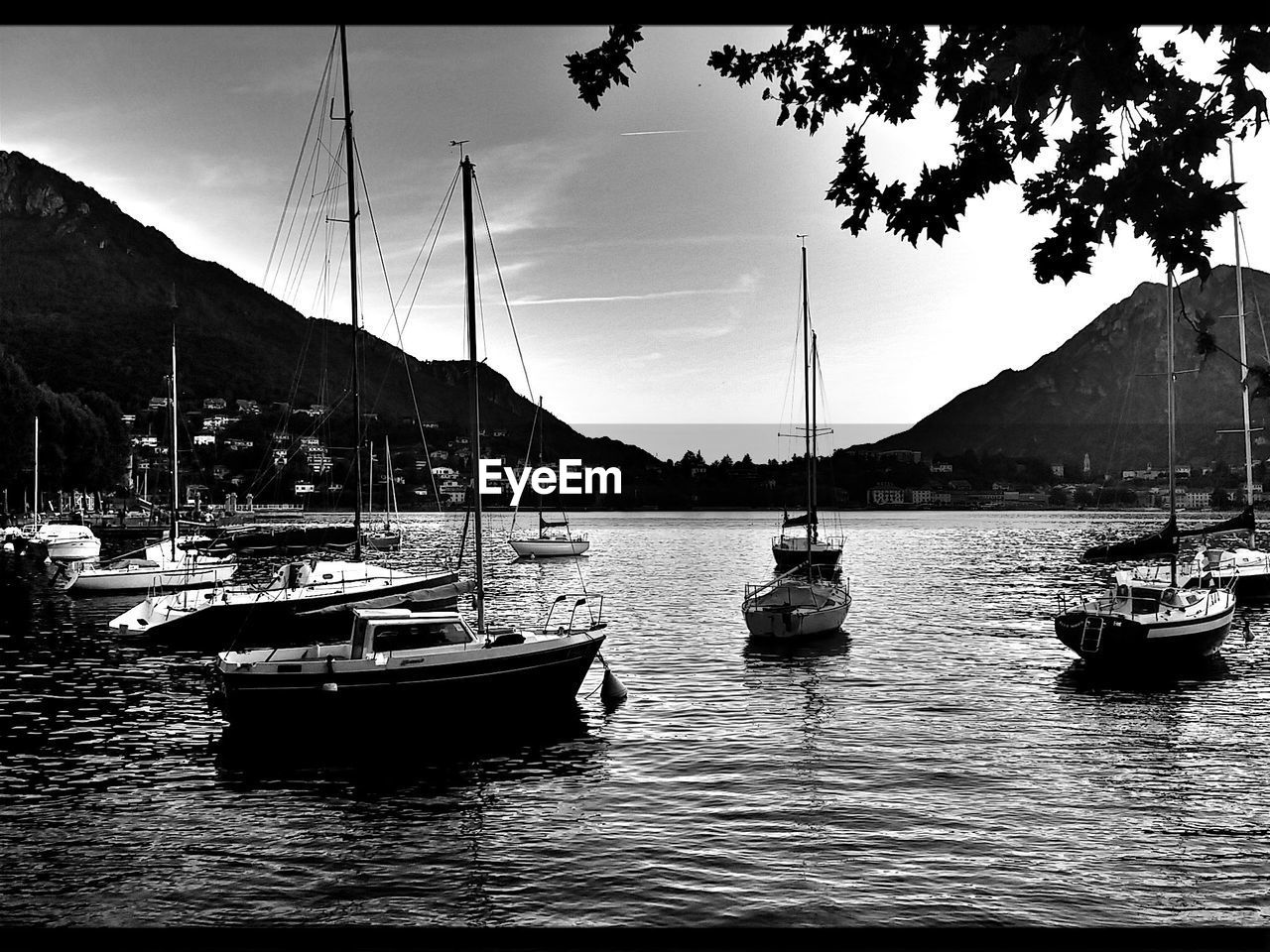 BOATS SAILING ON RIVER AGAINST SKY