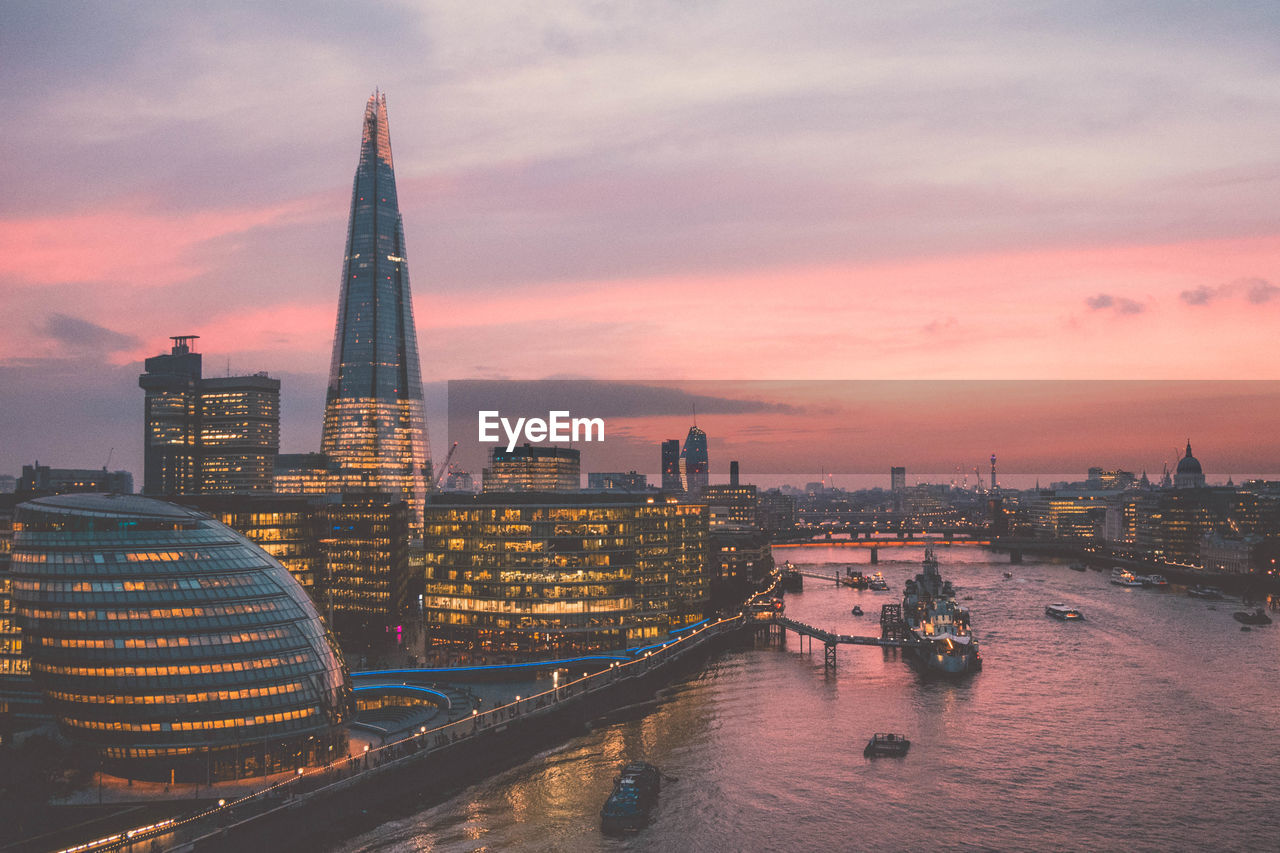 MODERN BUILDINGS AGAINST SKY DURING SUNSET