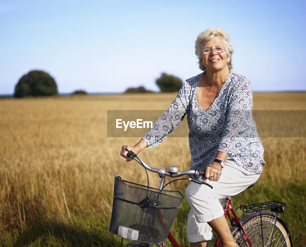 Older woman cycling and smiling