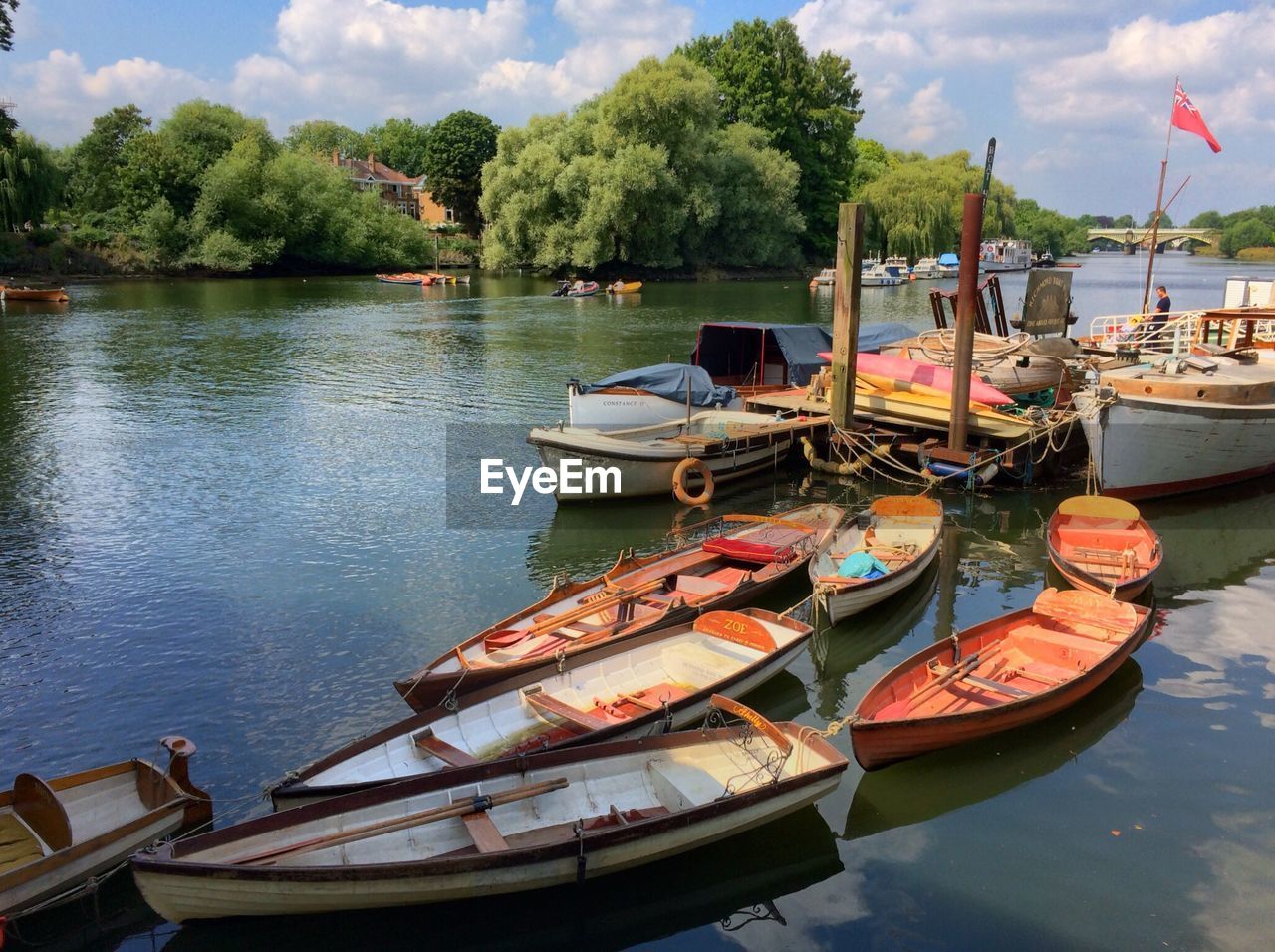 Boat moored in lake on sunny day