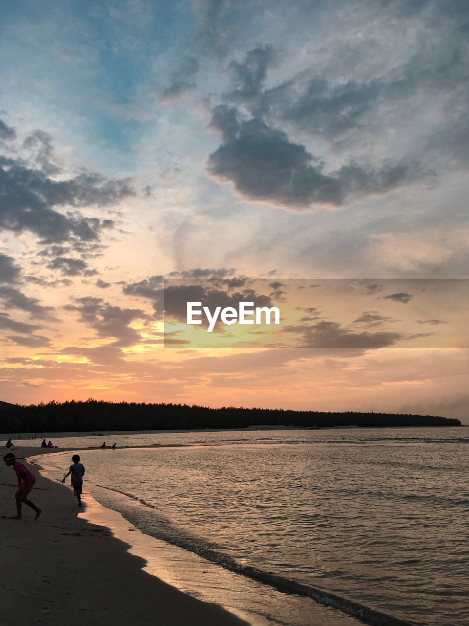 PEOPLE AT BEACH DURING SUNSET