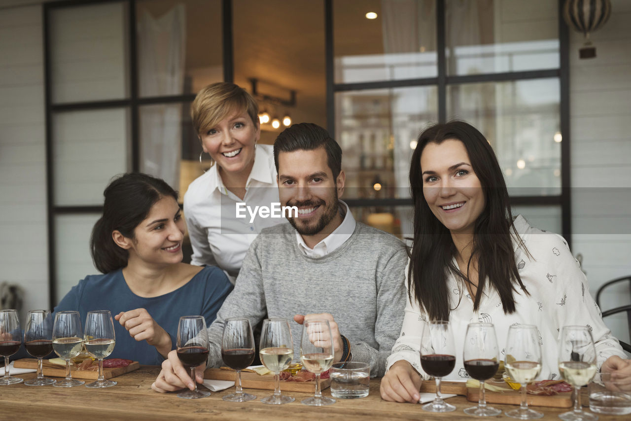 Portrait of smiling business people during winetasting at table
