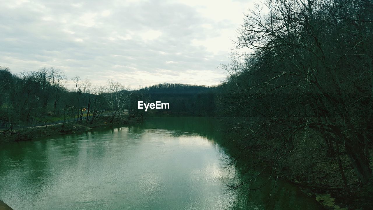 SCENIC VIEW OF LAKE AGAINST CLOUDY SKY