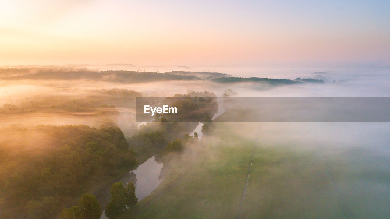 Summer nature landscape aerial panorama. morning fog over river, meadow and forest. nature sunlight 