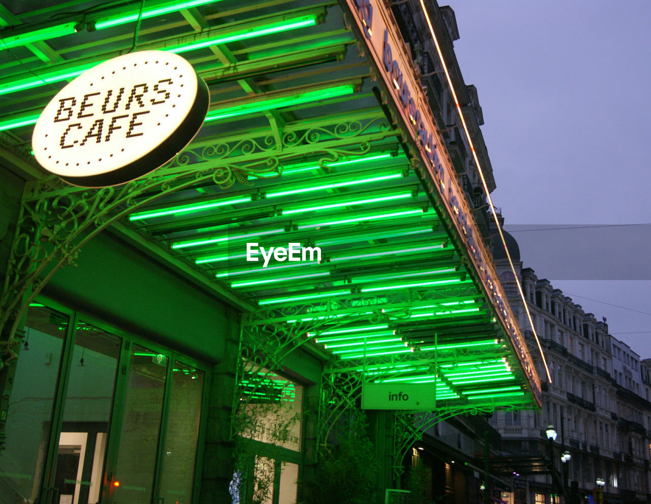 LOW ANGLE VIEW OF ILLUMINATED SIGNS AGAINST SKY