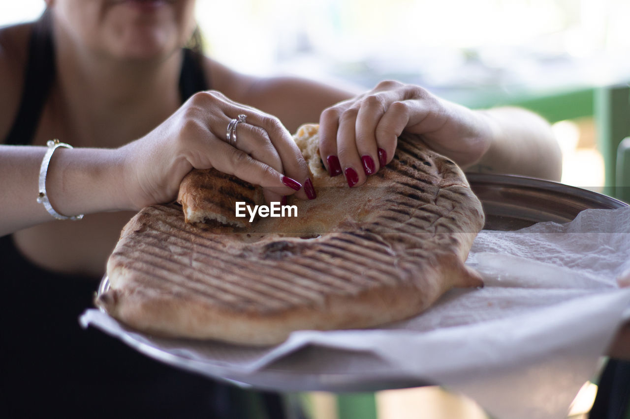 Midsection of woman holding bread