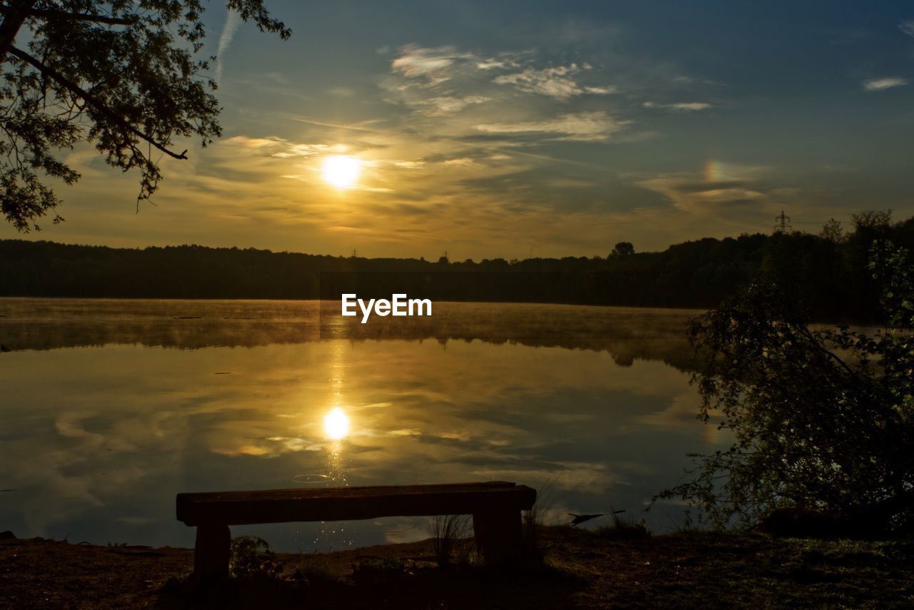 SCENIC VIEW OF LAKE AGAINST ORANGE SKY DURING SUNSET