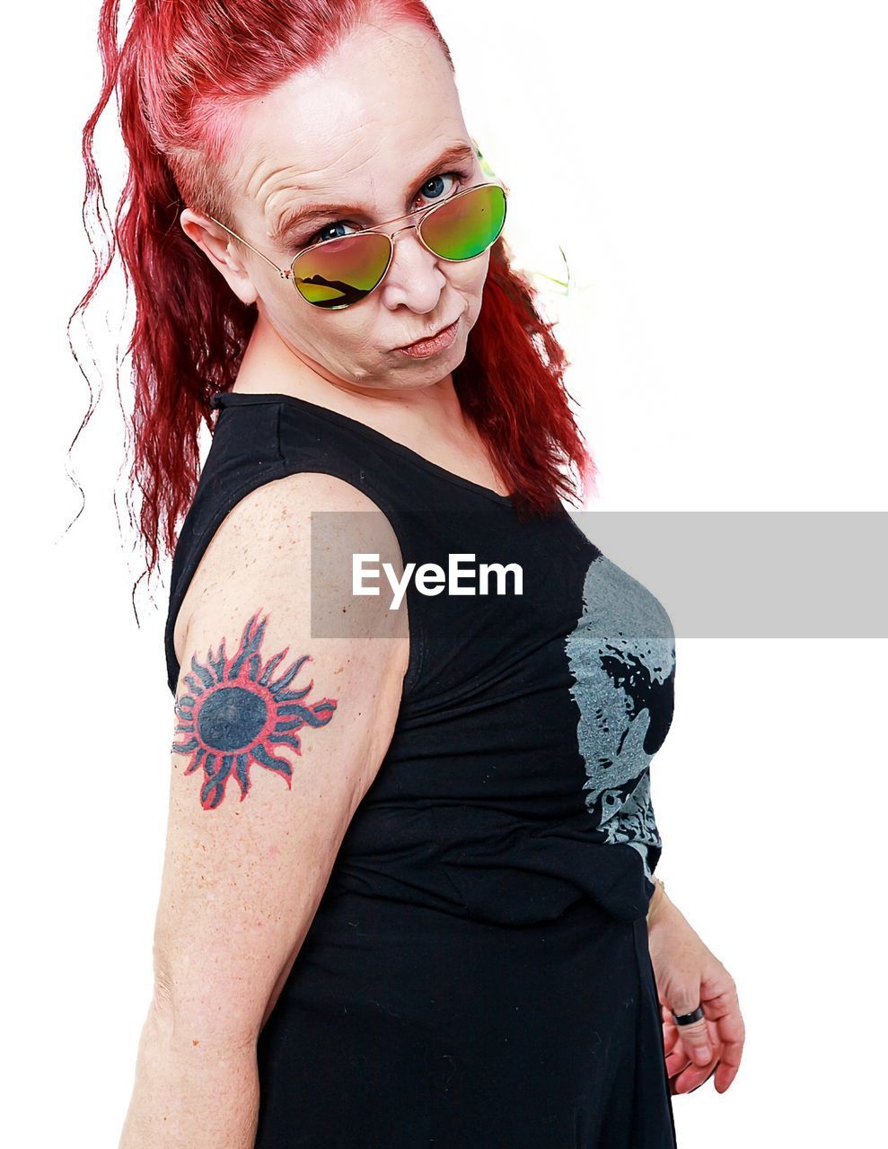 fashion, redhead, one person, portrait, adult, tattoo, white background, women, dyed red hair, red, hairstyle, studio shot, young adult, looking at camera, cut out, indoors, human hair, waist up, individuality, female, clothing, glasses, human face, child, arts culture and entertainment, pink, cool attitude, lifestyles, make-up, body adornment, alternative lifestyle, dyed hair, multi colored, costume, sunglasses, emotion, paint, arm