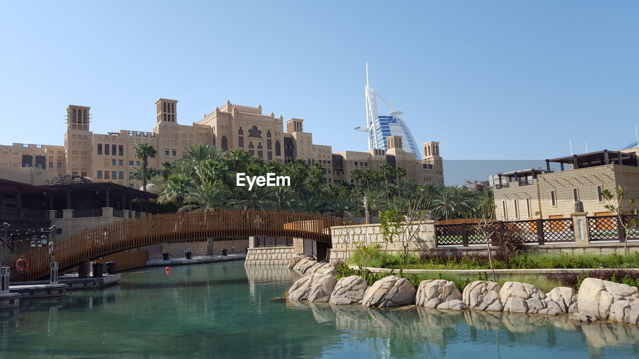 VIEW OF RIVER WITH BUILDINGS IN BACKGROUND