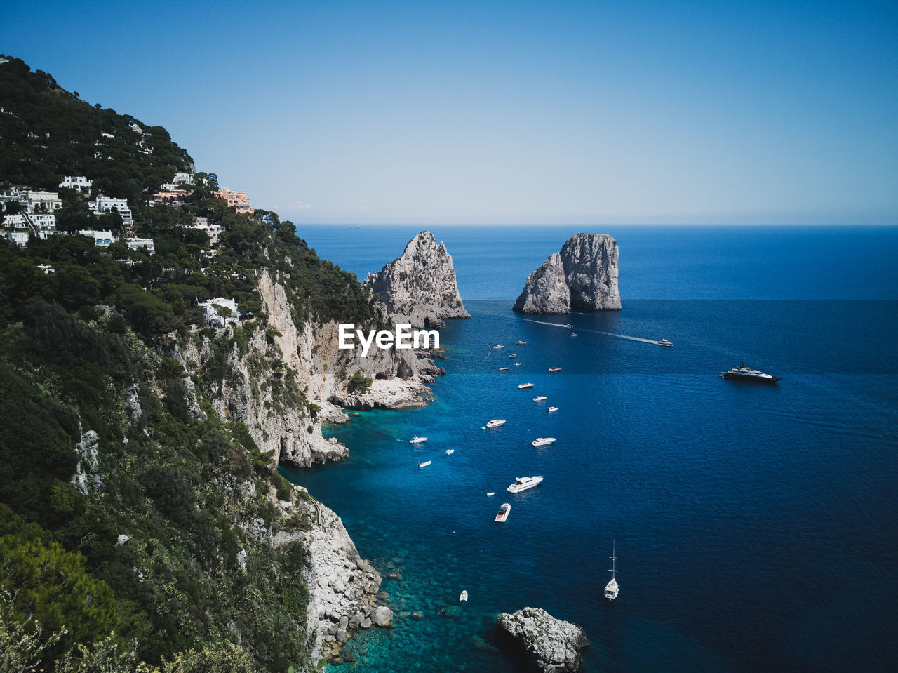 High angle view of boats in sea against blue sky