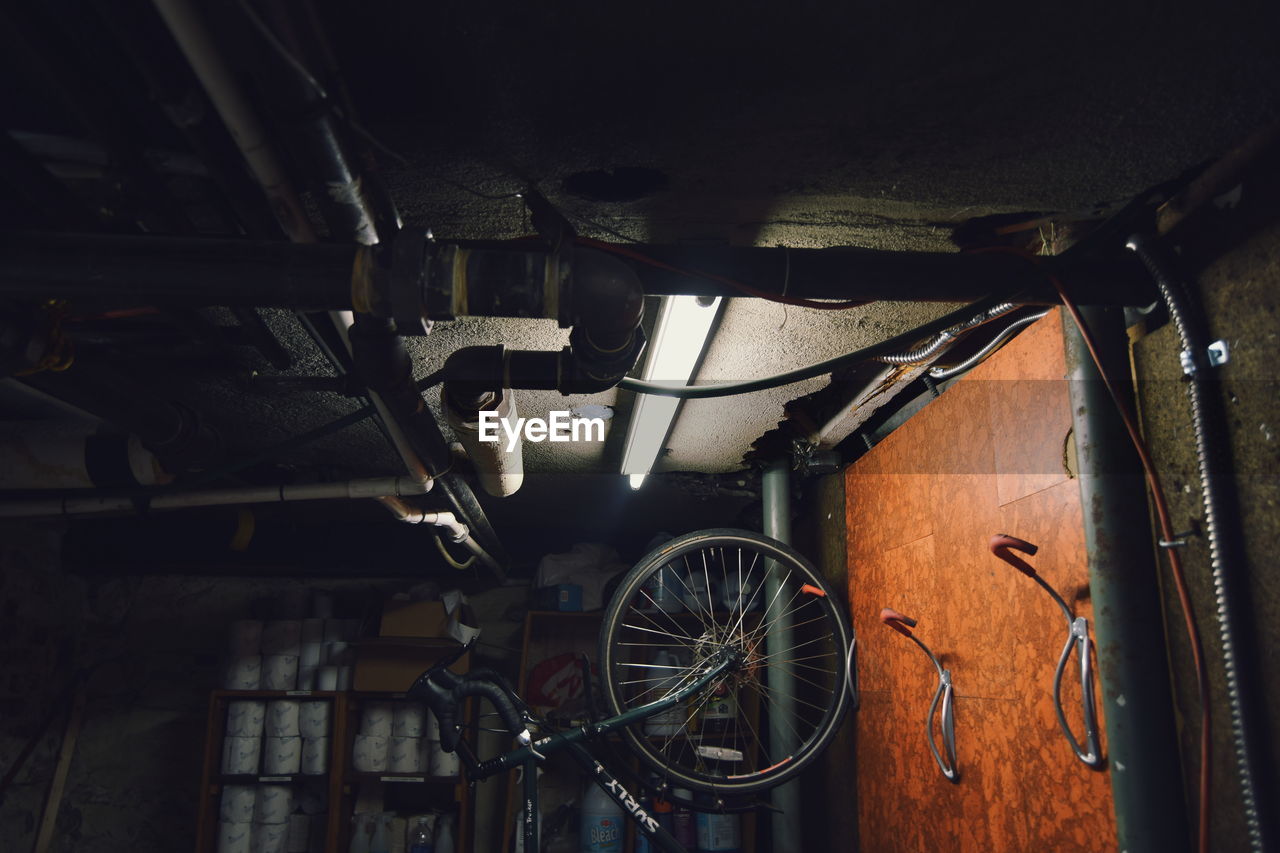 bicycle, mode of transport, transportation, wheel, land vehicle, no people, indoors, hanging, auto repair shop, workshop, technology, tire, day