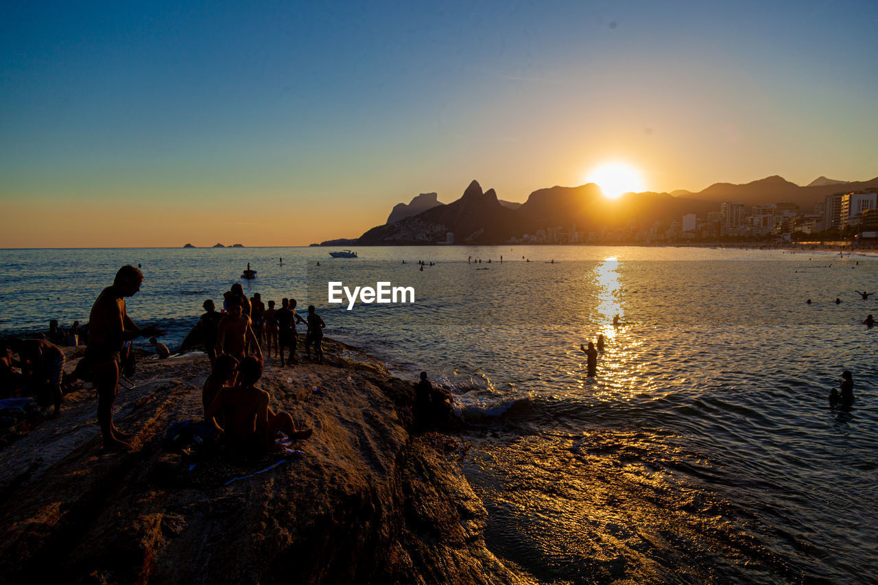 SCENIC VIEW OF BEACH AGAINST SKY DURING SUNSET