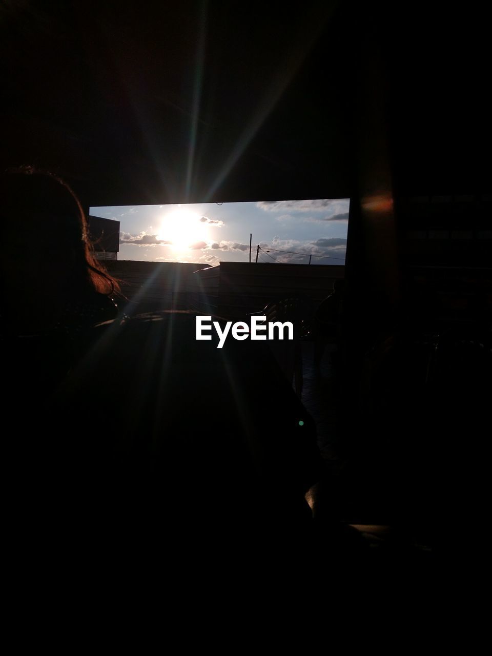 REAR VIEW OF SILHOUETTE WOMAN IN BUS AT NIGHT