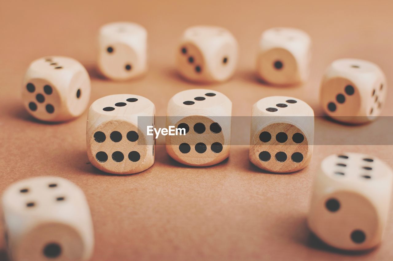 Closeup shot of wooden dices with numbers on brown background