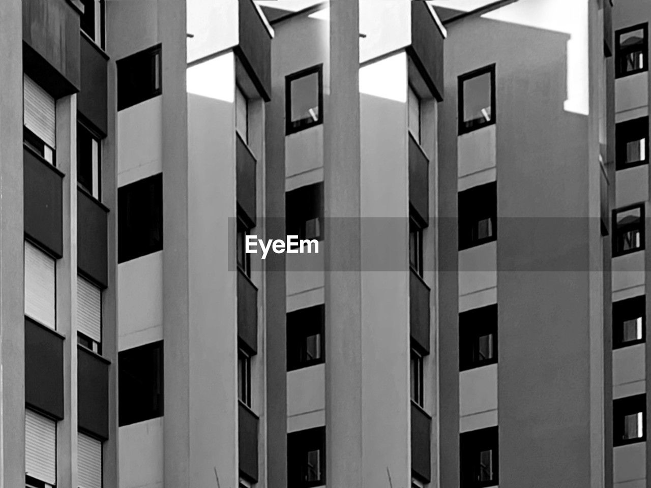 architecture, building exterior, built structure, building, window, black and white, monochrome, tower block, full frame, city, no people, monochrome photography, facade, black, pattern, residential district, repetition, apartment, backgrounds, in a row, line, font, office, outdoors, office building exterior, day, skyscraper, low angle view