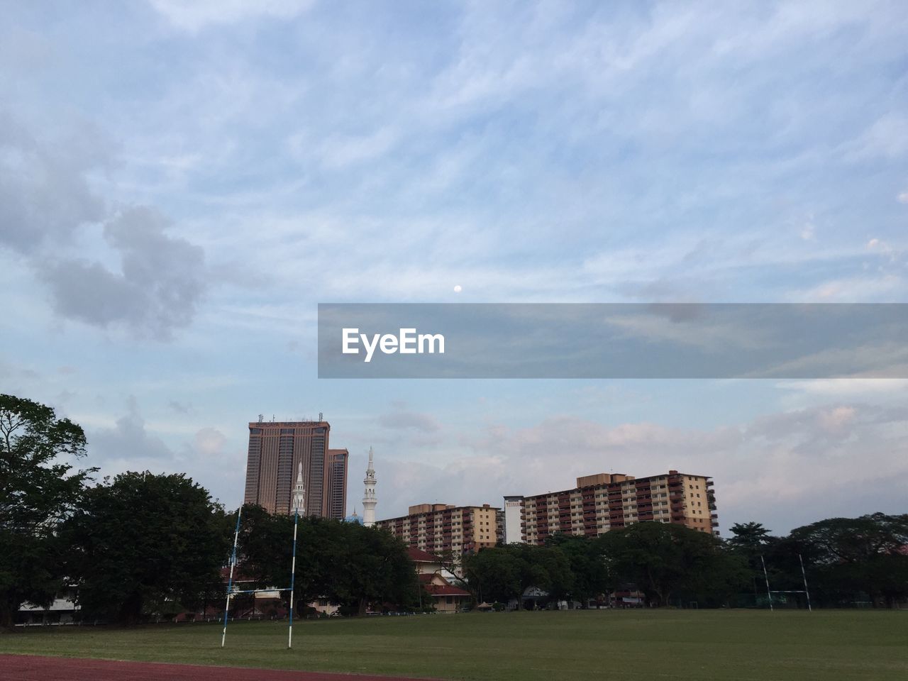 VIEW OF BUILDINGS AGAINST CLOUDY SKY