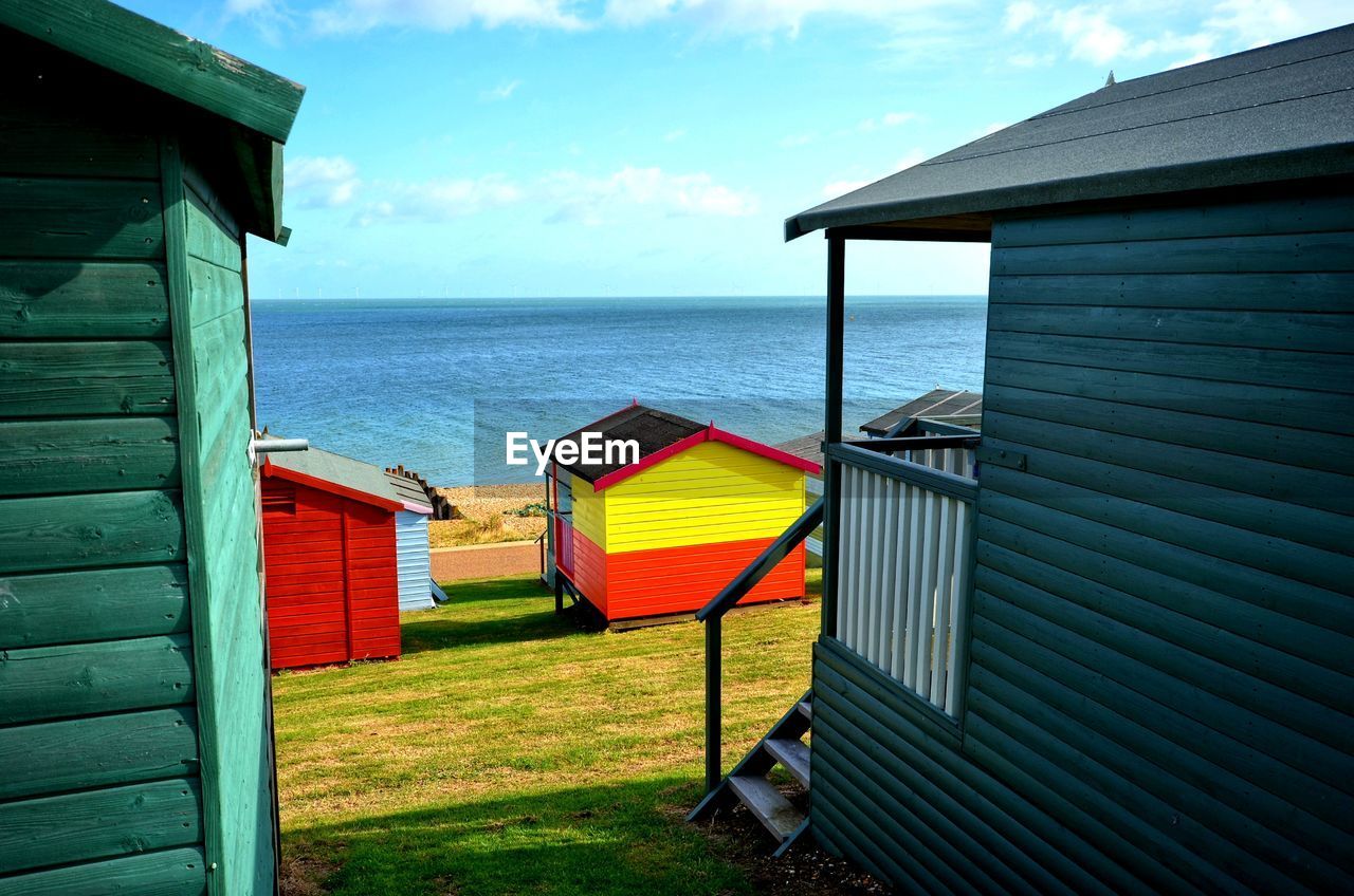 LIFEGUARD HUT ON BEACH AGAINST SKY