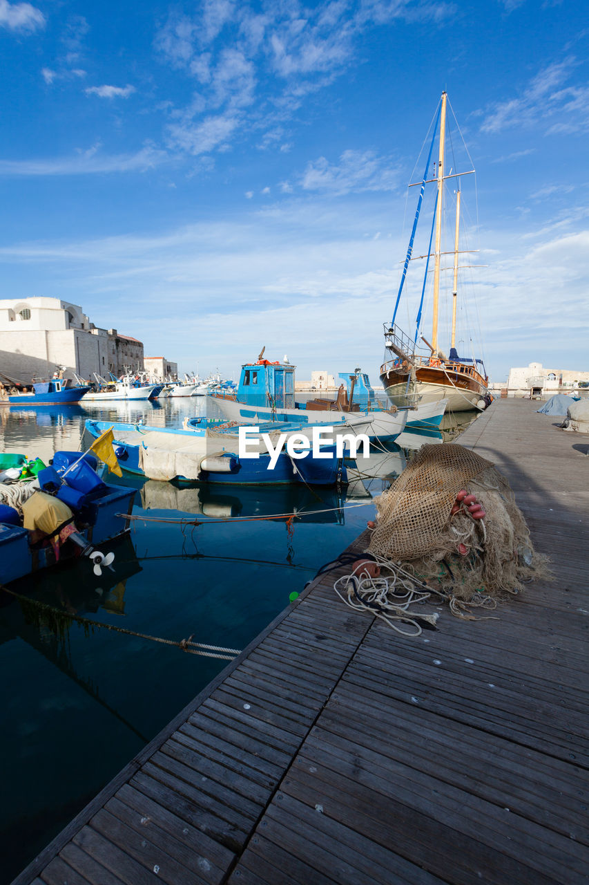 BOATS MOORED IN HARBOR