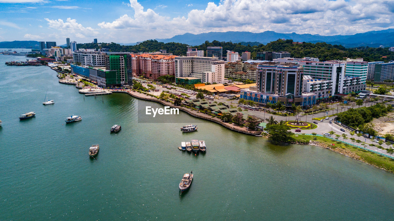 High angle view of river and cityscape against sky