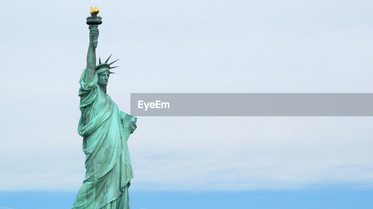 Low angle view of statue against sky