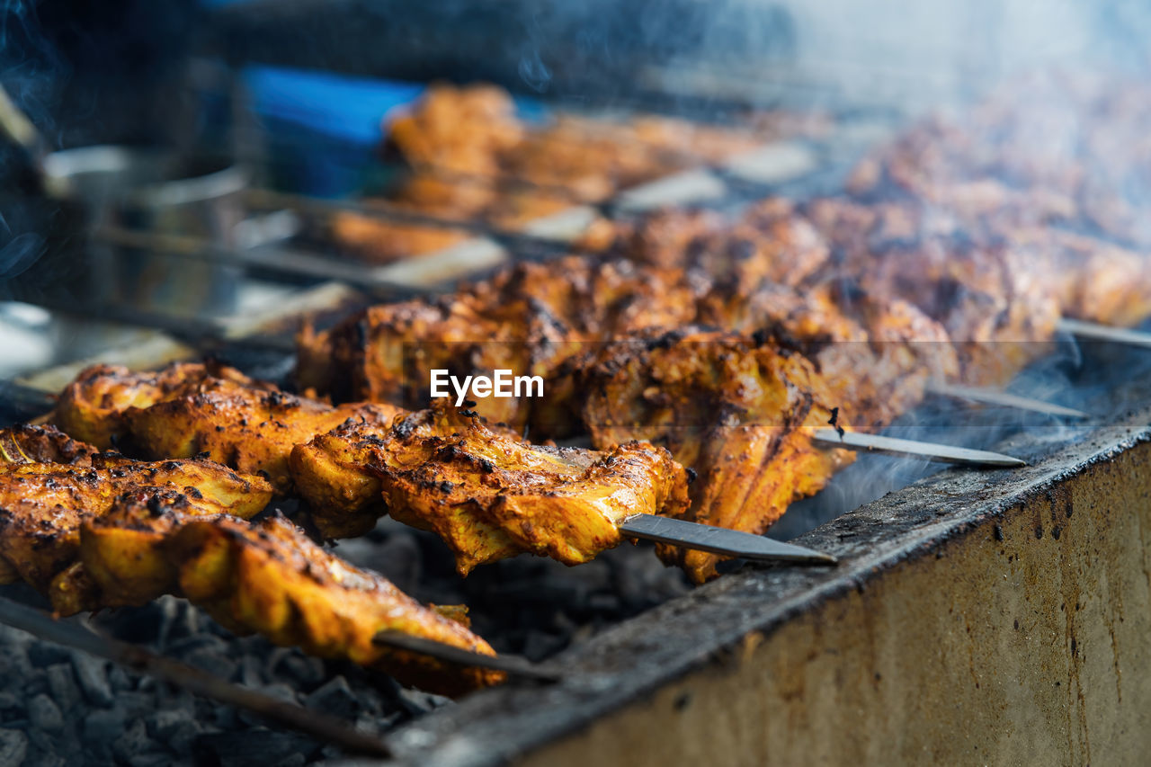 Chicken skew kebab barbeque. traditional indian and paksitan dish cooked on charcoal and flame.
