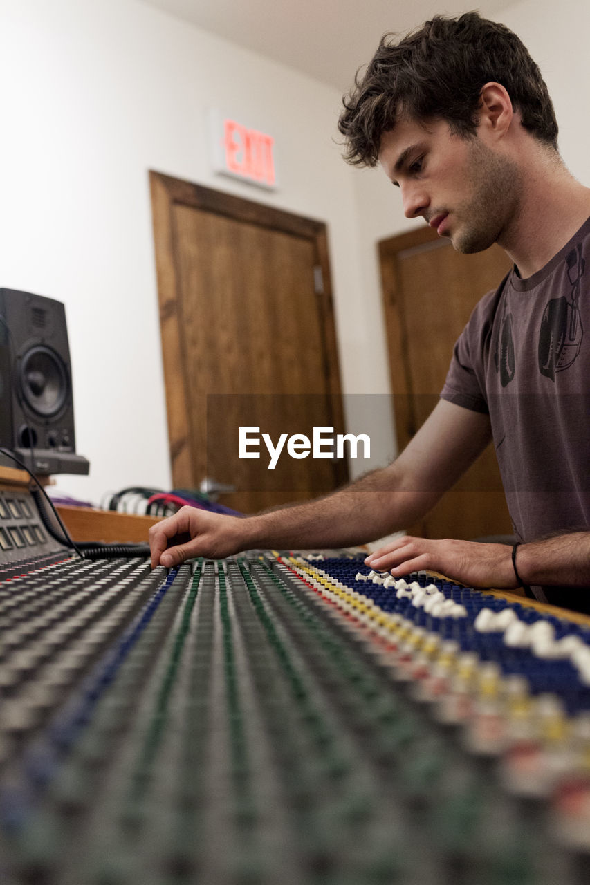 Audio engineer working at an instrument panel