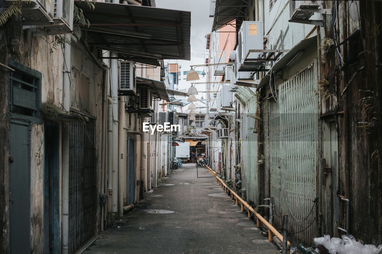 Narrow street amidst buildings in city