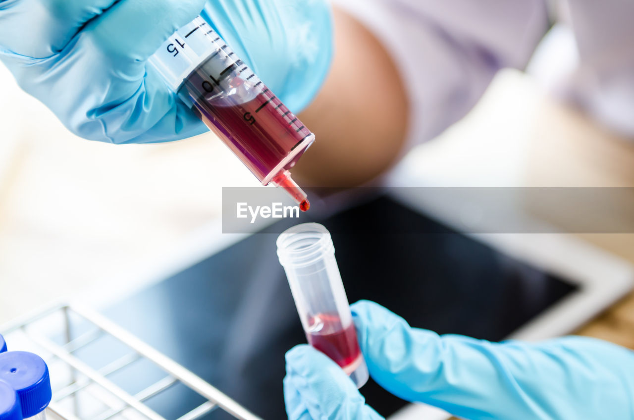 Cropped hands of scientist examining chemical