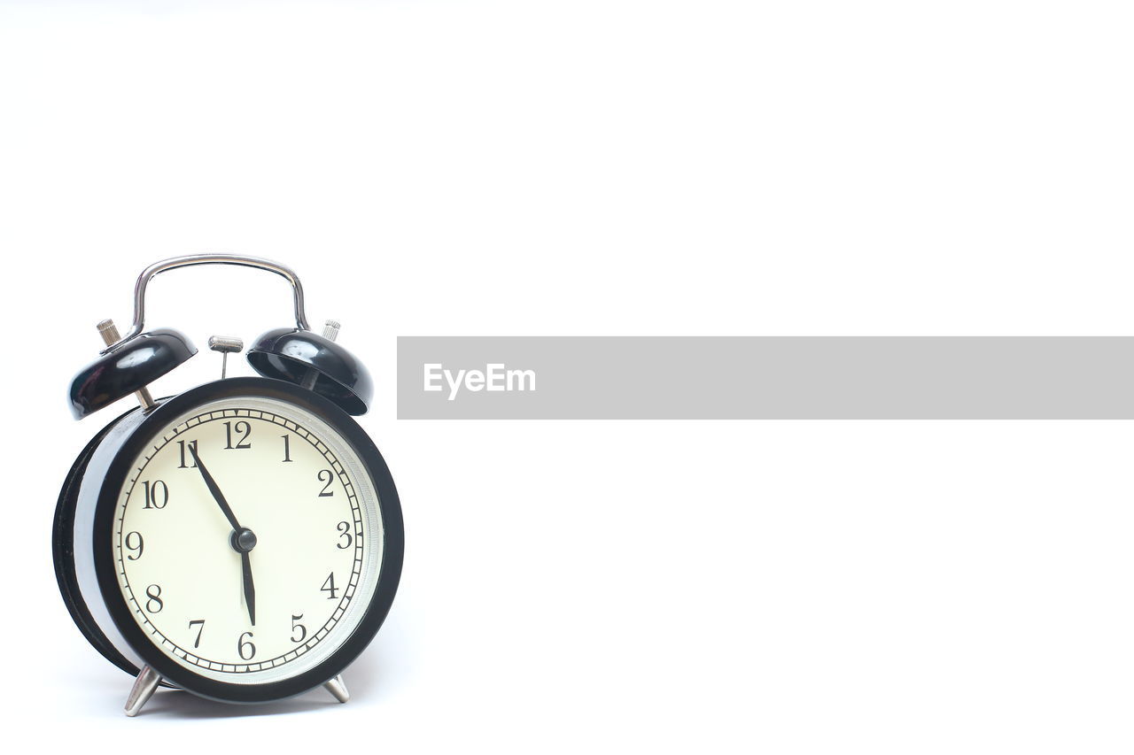 Close-up of alarm clock on white background