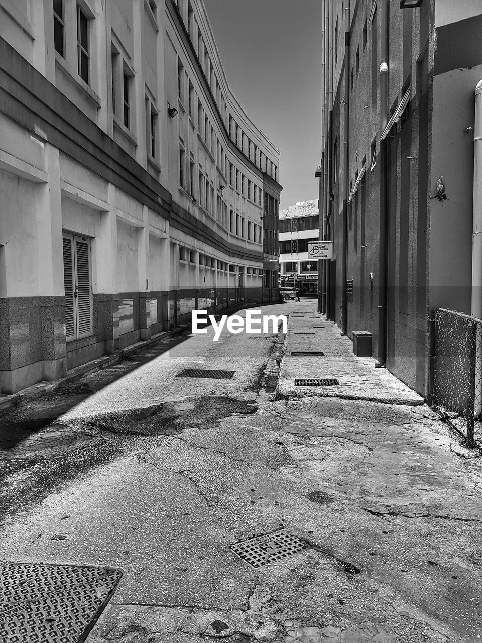 EMPTY ROAD AMIDST BUILDINGS