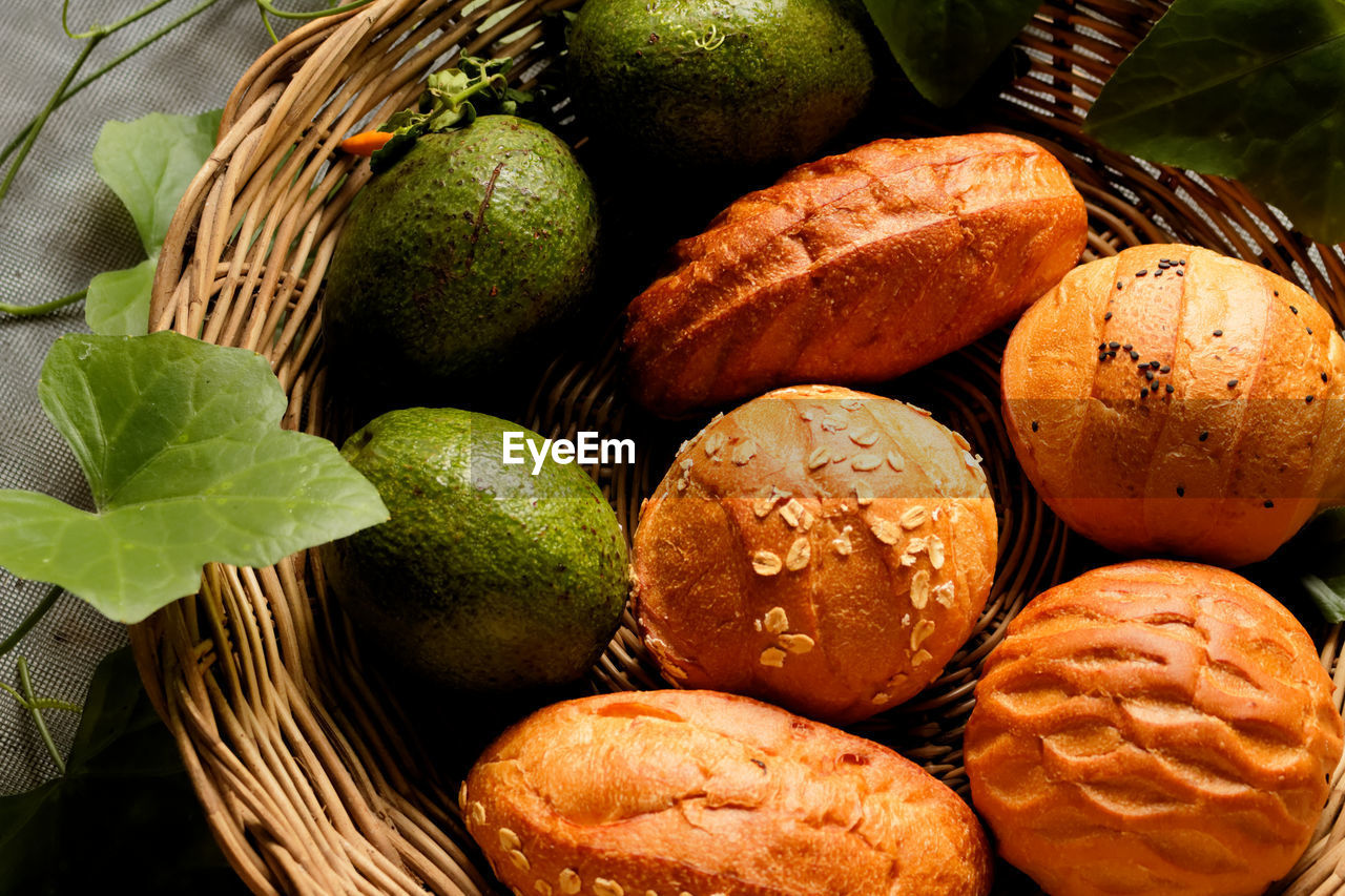 Bread and avocado in basket decorate by gourd leaf