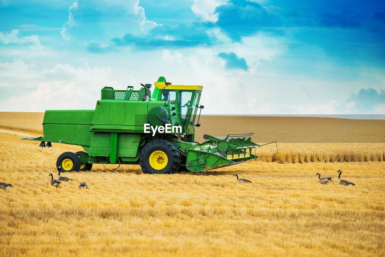 Tractor on field against sky