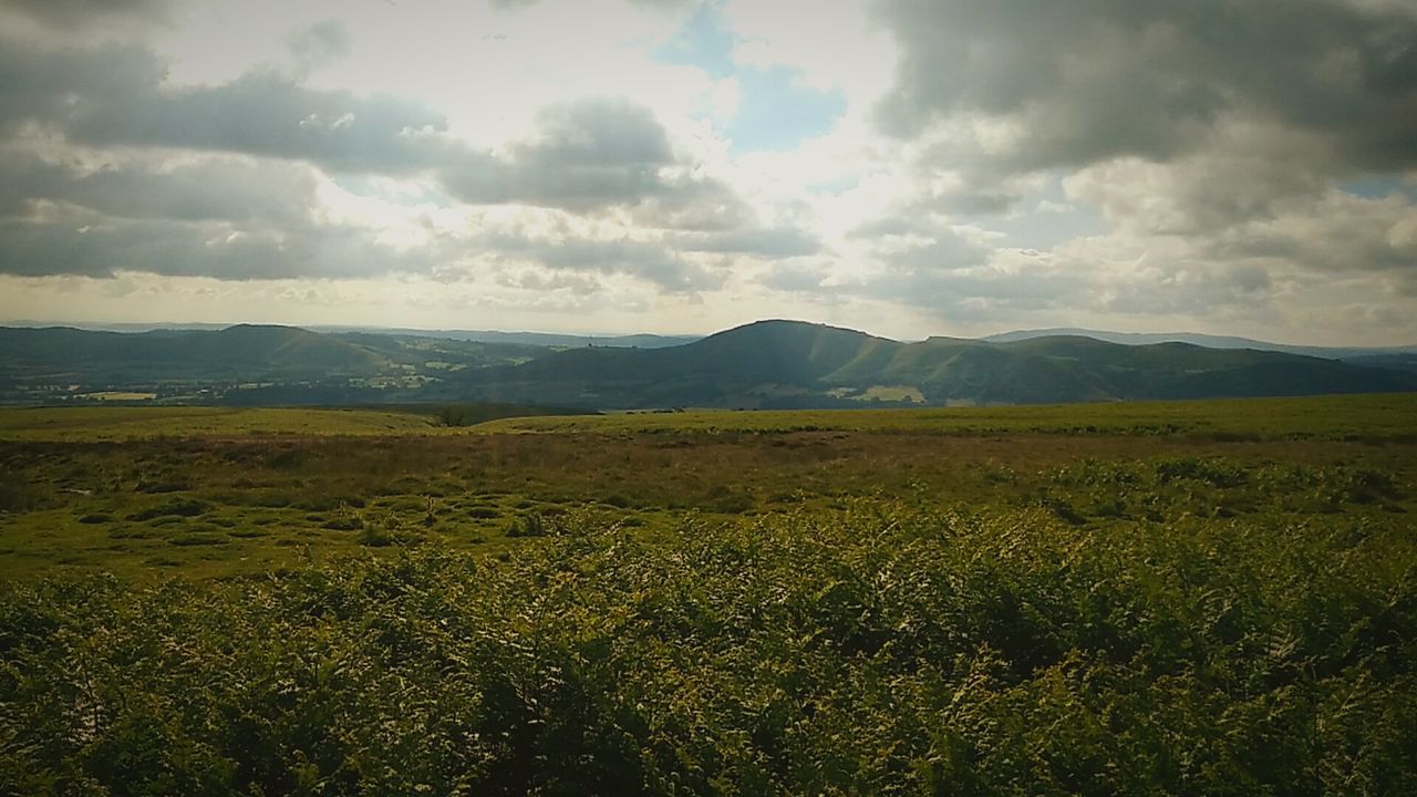 SCENIC VIEW OF MOUNTAINS AGAINST CLOUDY SKY