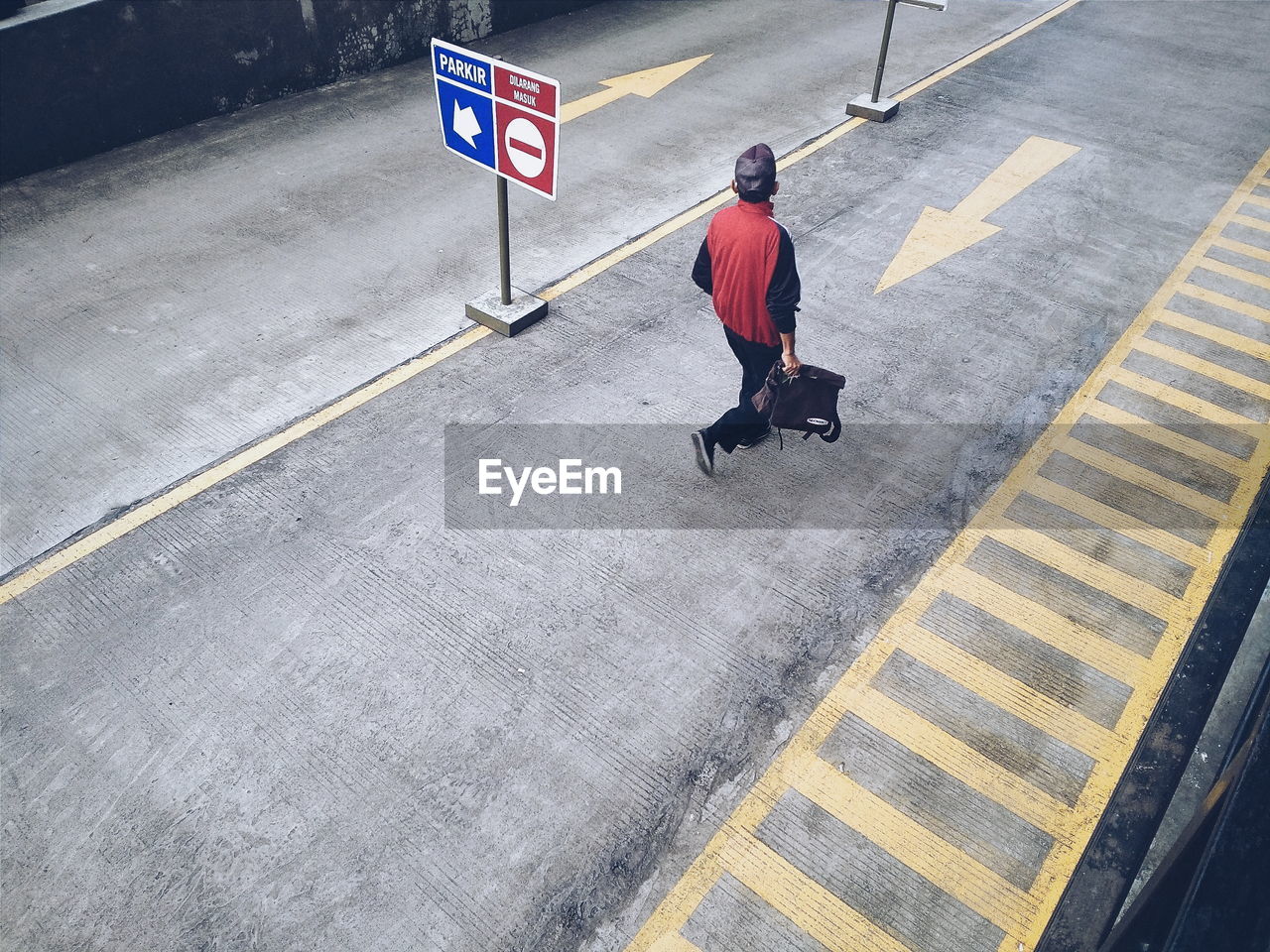 High angle view of man walking on road