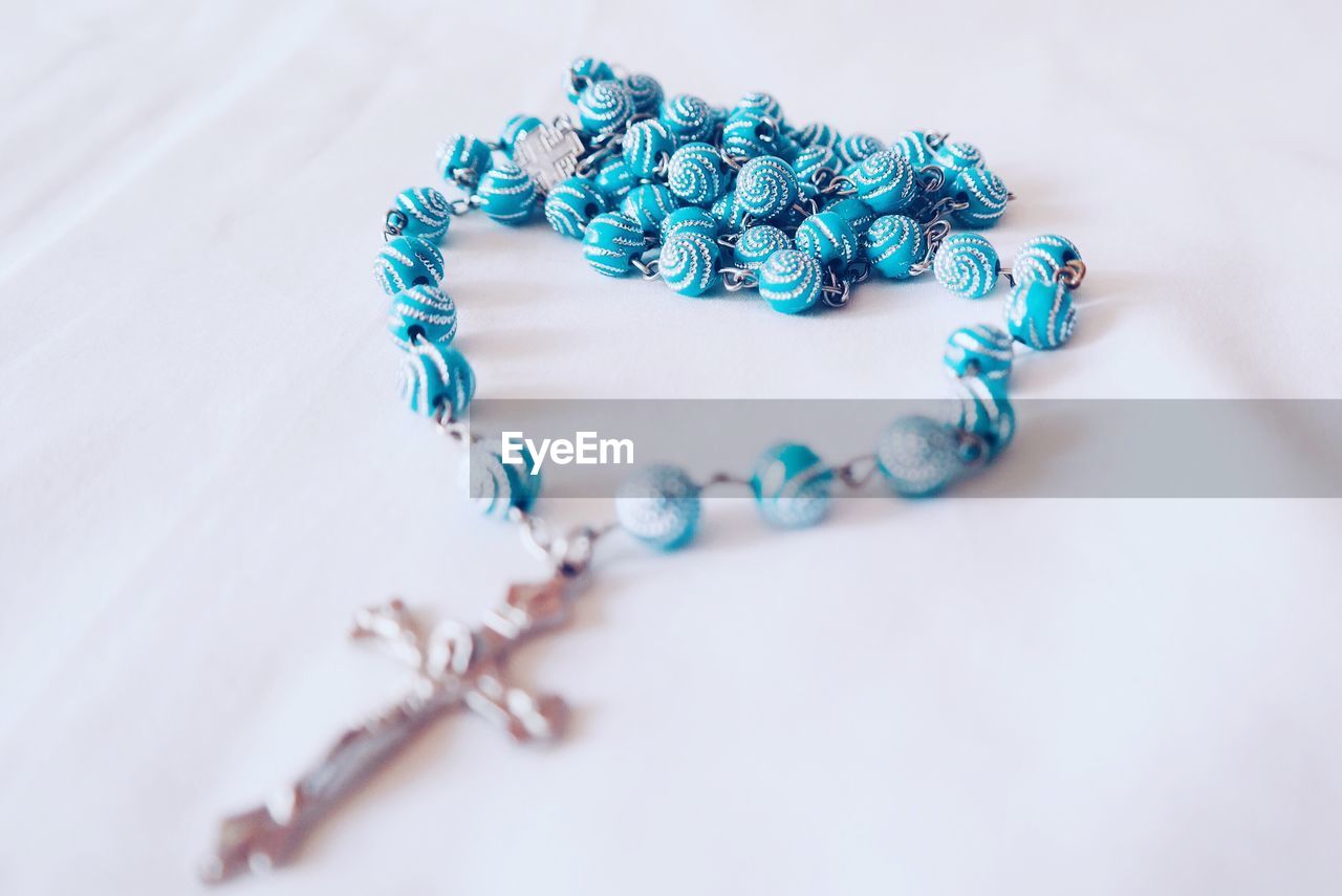 Close-up of rosary beads on table