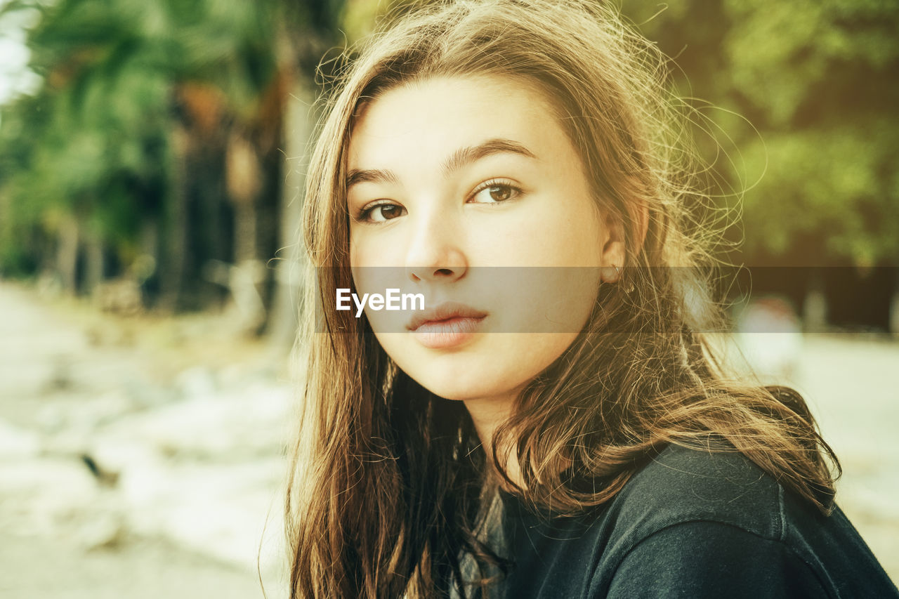 Pensive teenage girl in nature close-up face