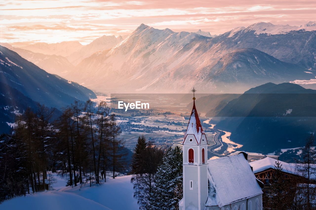 Church against mountains during winter