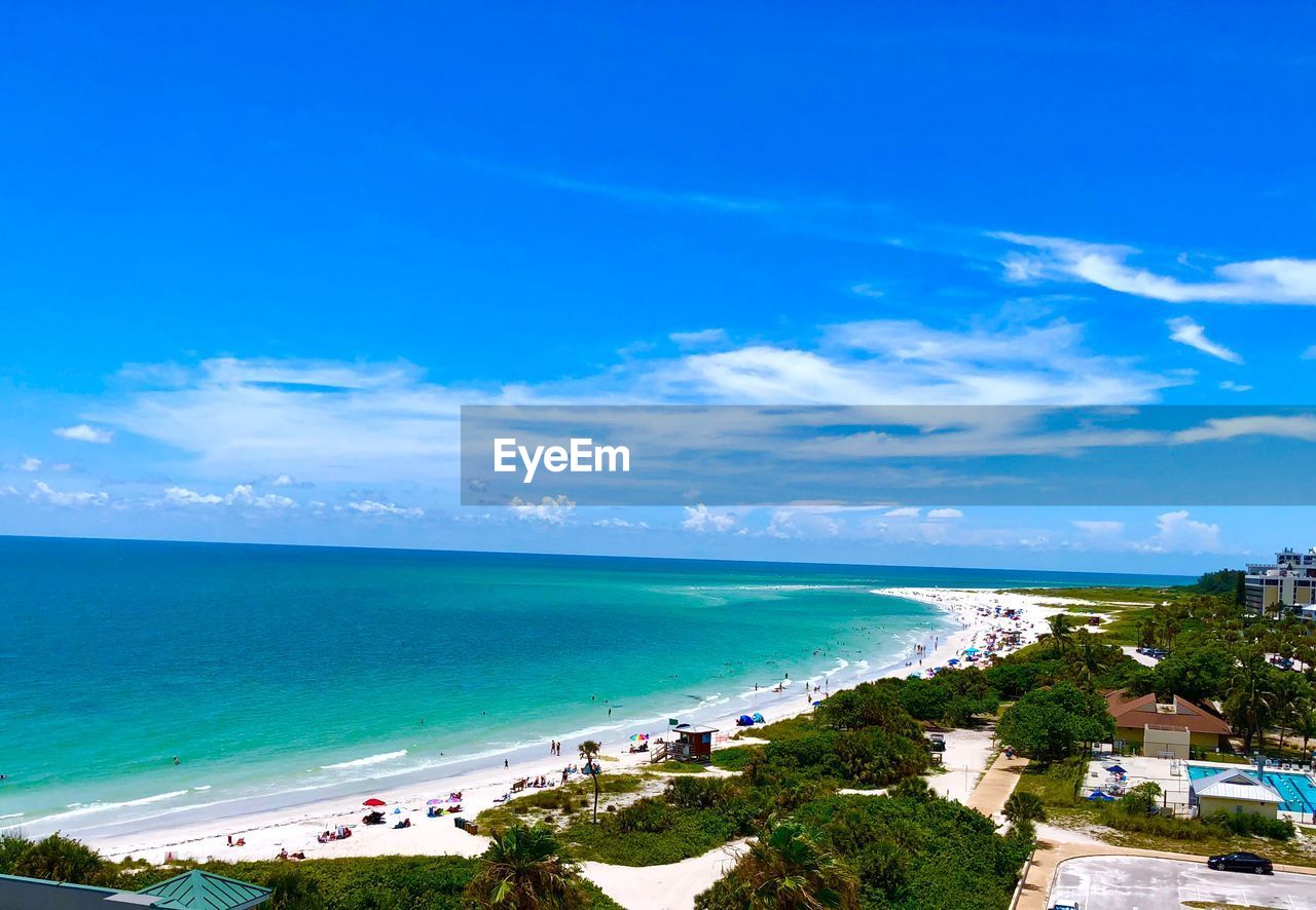 SCENIC VIEW OF BEACH AGAINST BLUE SKY