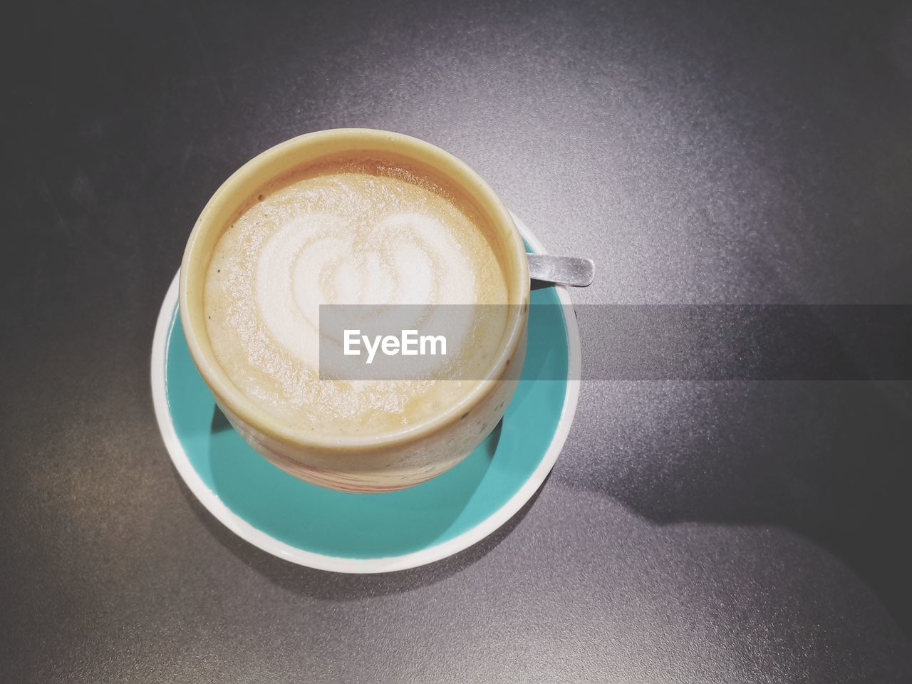 CLOSE-UP OF CAPPUCCINO WITH COFFEE CUP