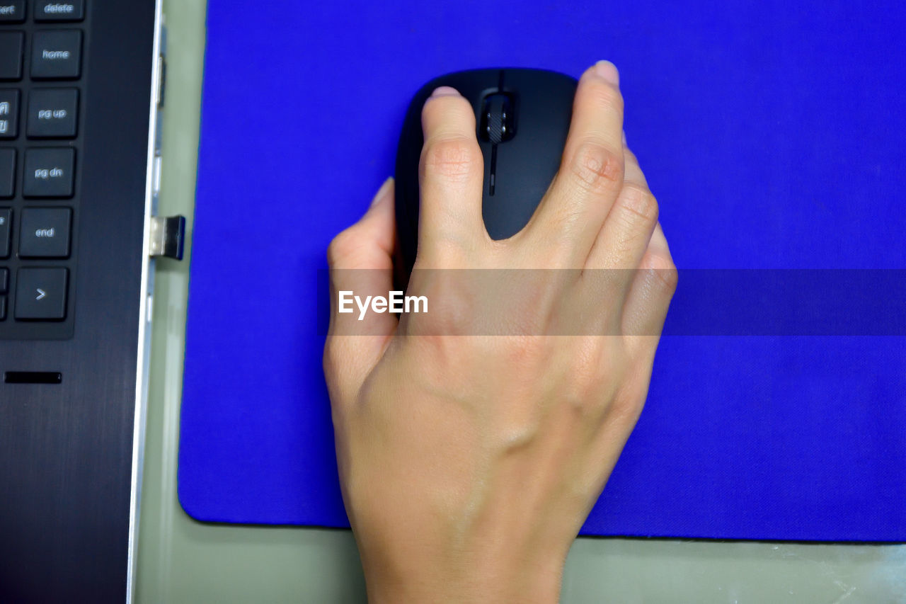 Cropped image of woman hand holding computer mouse 