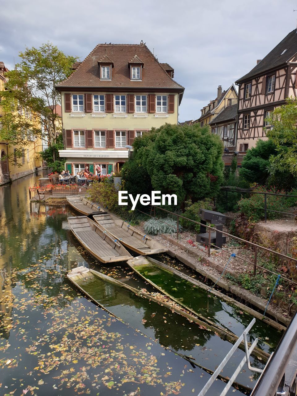 HOUSES BY CANAL AGAINST BUILDINGS