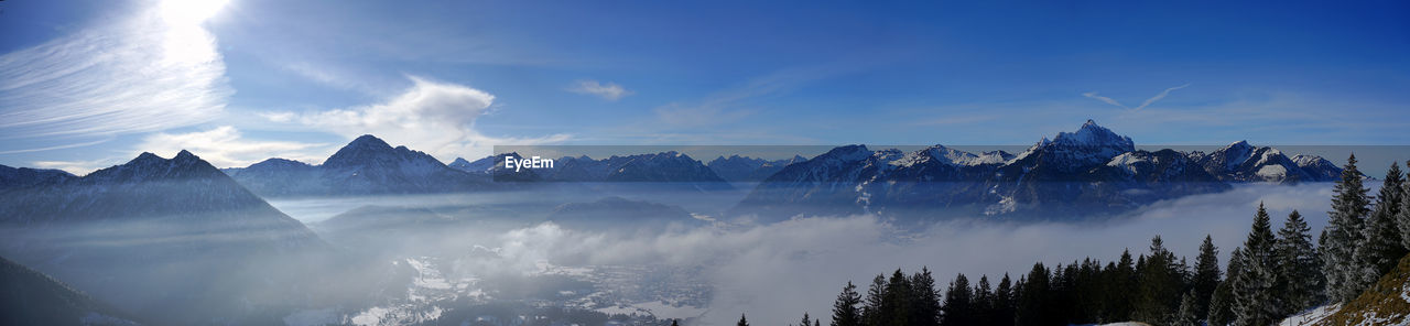 Panoramic view of snowcapped mountains against sky