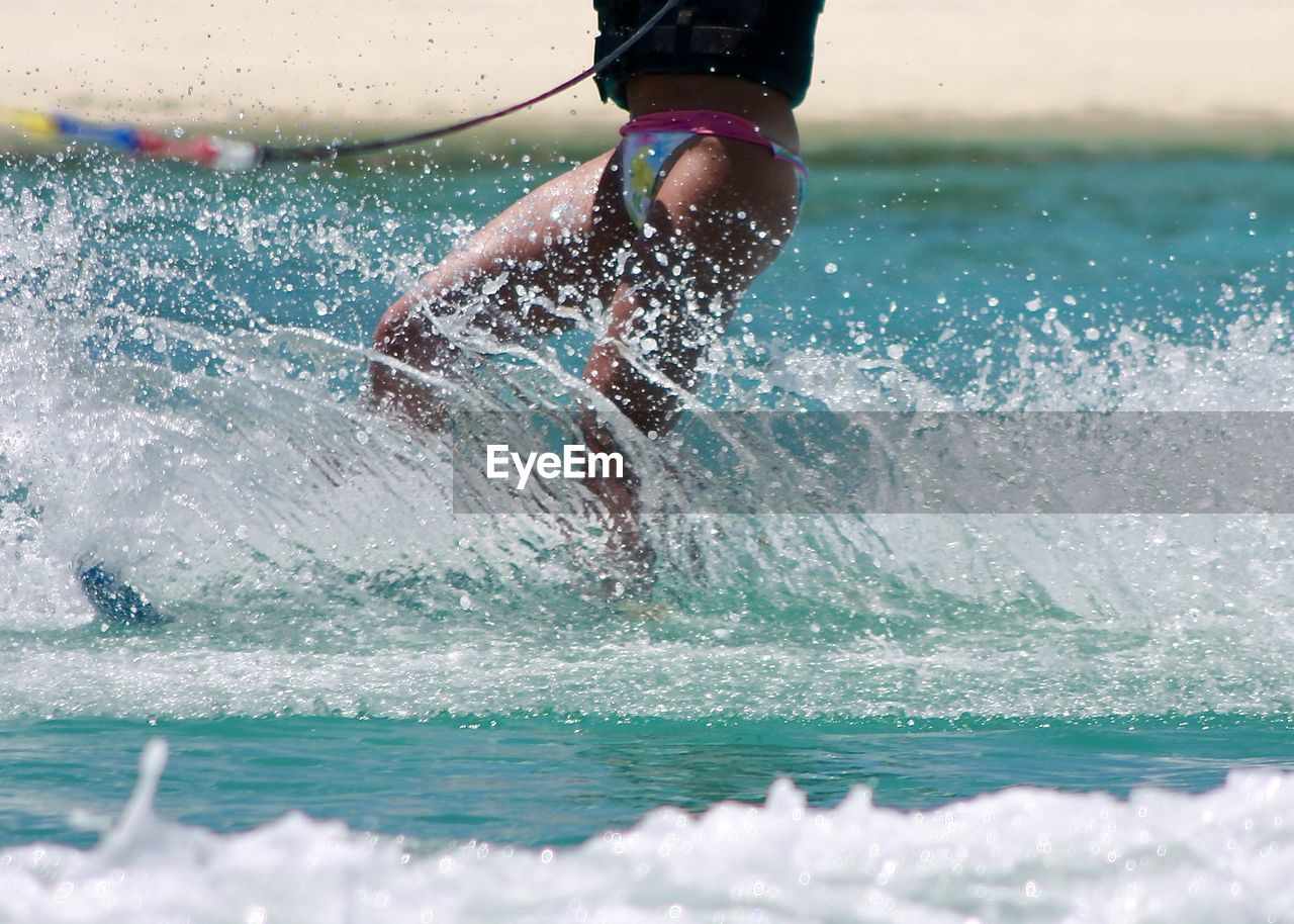 Woman surfing in sea