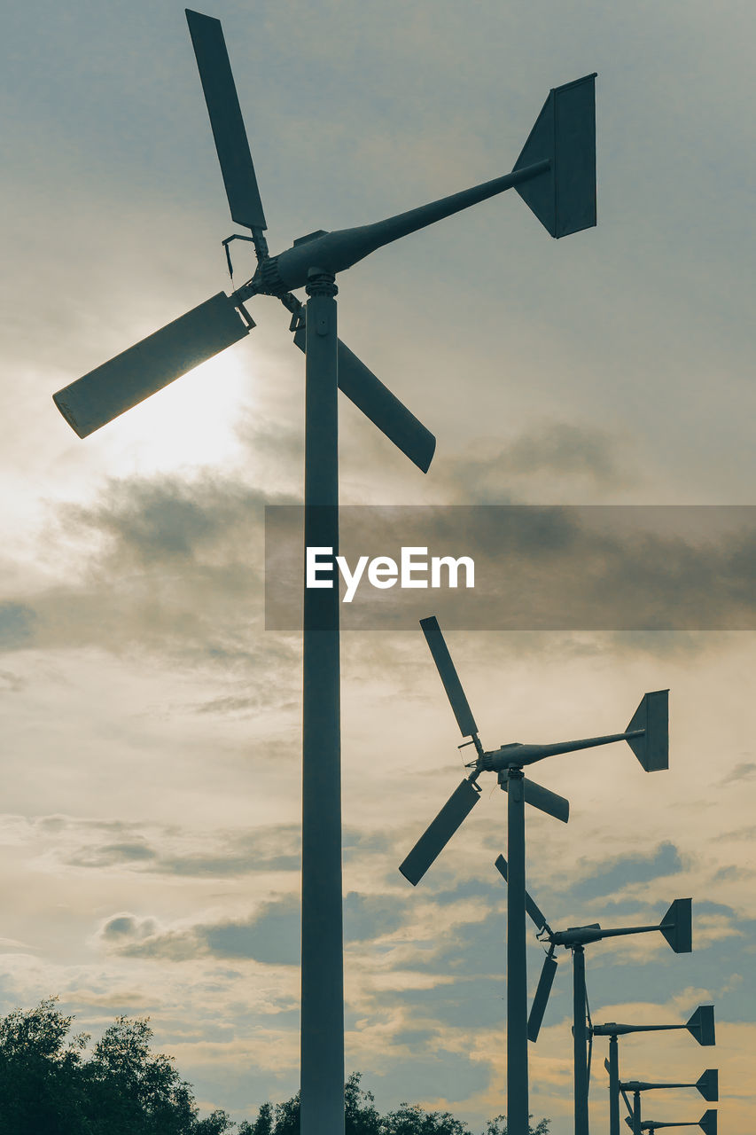 LOW ANGLE VIEW OF WINDMILLS AGAINST SKY