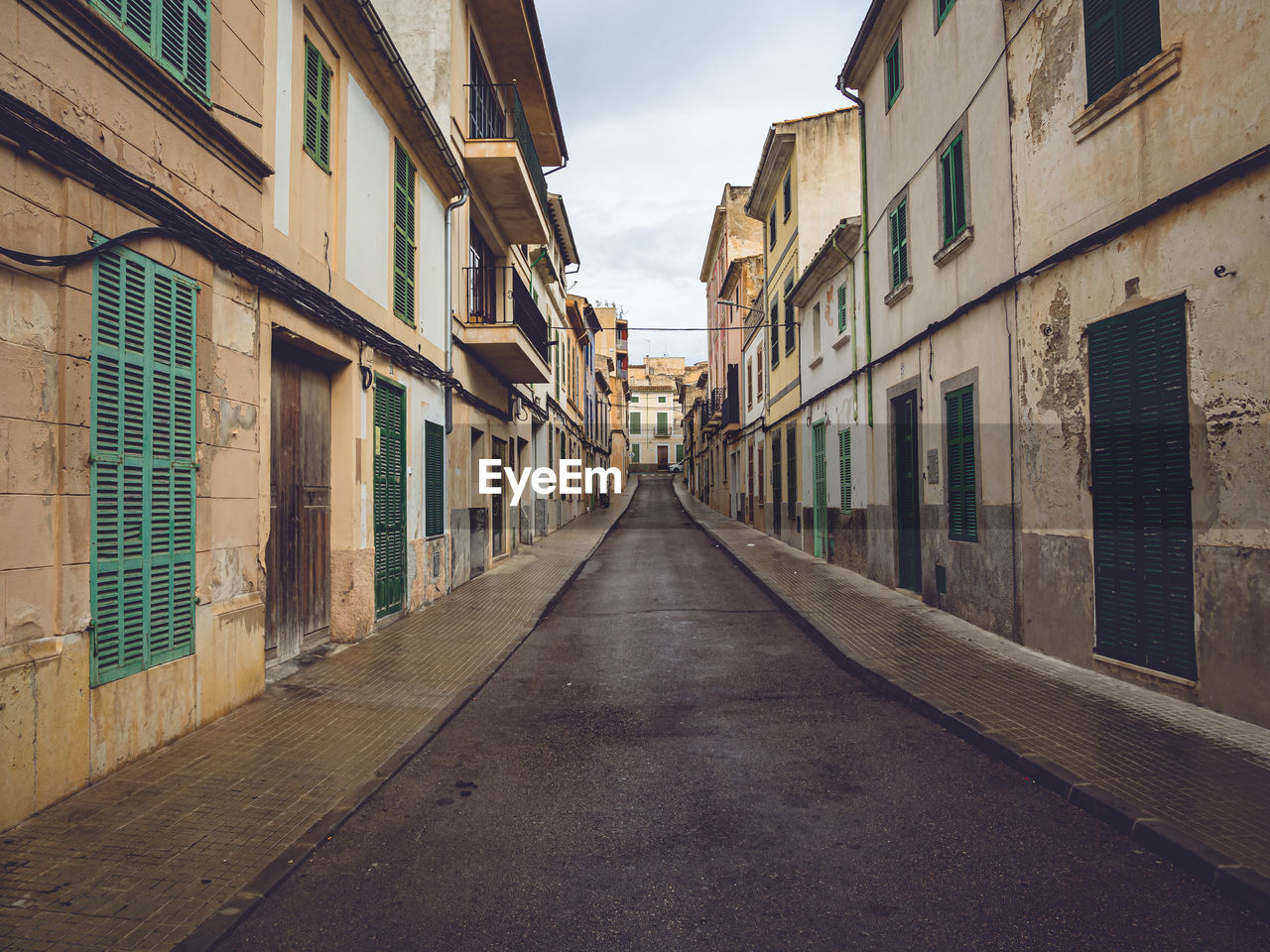 NARROW STREET AMIDST BUILDINGS