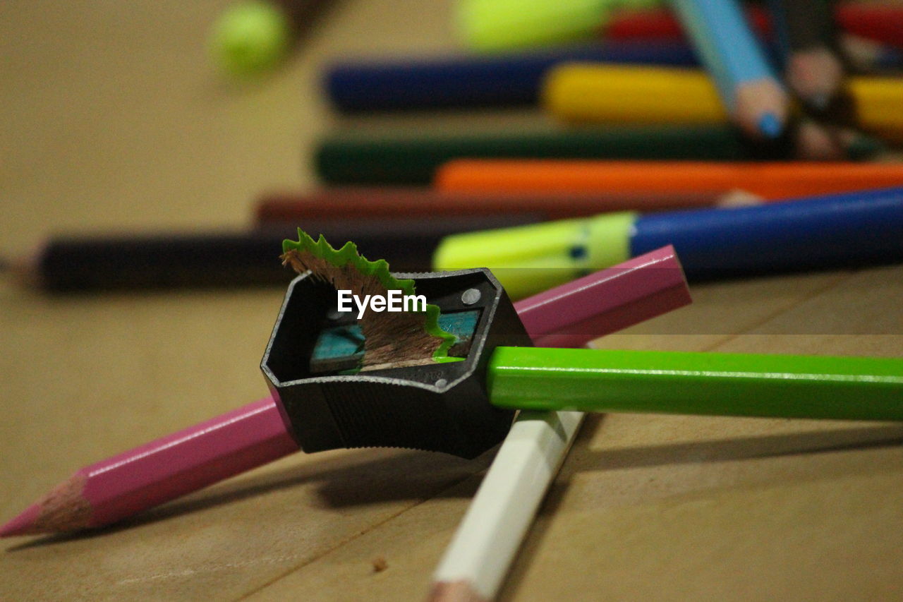 Close-up of pencils and sharpener on table