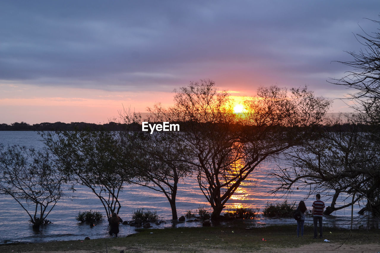 SCENIC VIEW OF LAKE AGAINST ORANGE SKY