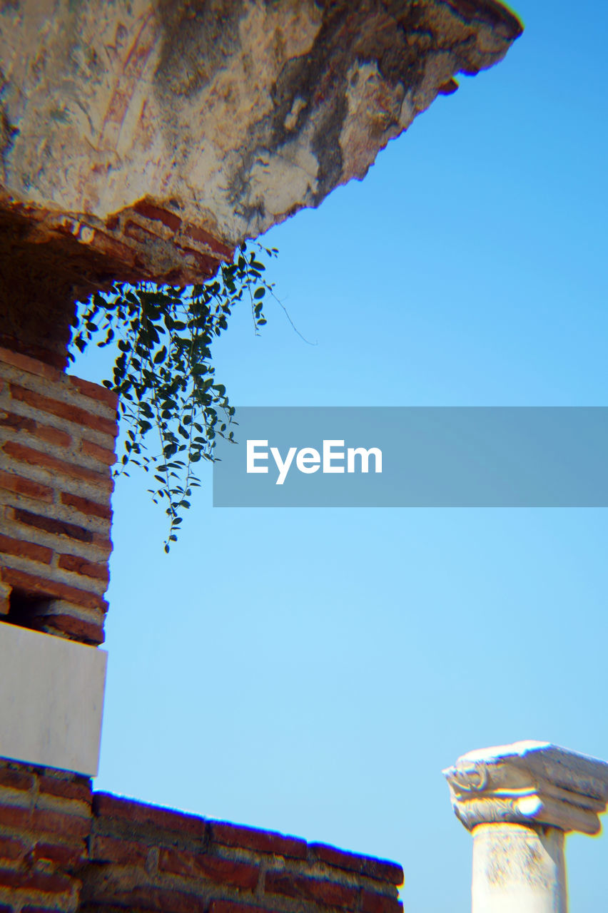 LOW ANGLE VIEW OF BUILT STRUCTURES AGAINST BLUE SKY