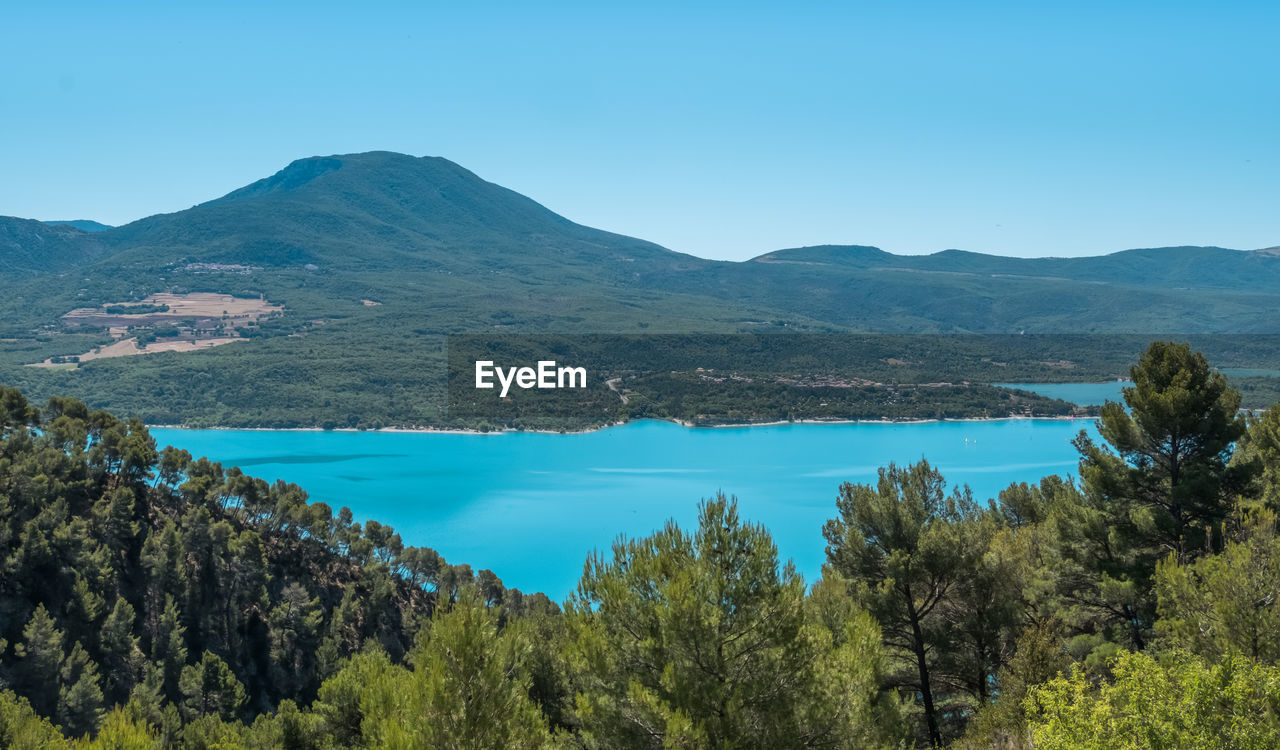 Scenic view of lake and mountains against clear sky